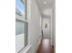 Hallway featuring hardwood floors, large windows, and natural light at 115 W Hiawatha St, Tampa, FL 33604