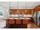 Gourmet kitchen with custom cabinets, stainless appliances, oversized island, and designer pendant lighting at 115 W Hiawatha St, Tampa, FL 33604