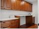 A laundry room with custom wooden cabinets, subway tile backsplash, and a modern countertop at 115 W Hiawatha St, Tampa, FL 33604