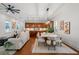 Open concept living area with hardwood floors, large windows, and a seamless transition to the kitchen at 115 W Hiawatha St, Tampa, FL 33604
