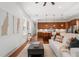 Open-concept living room and kitchen boast hardwood floors, stainless appliances, and eat-in island at 115 W Hiawatha St, Tampa, FL 33604