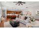 Open concept living area with hardwood floors, comfortable seating, and a seamless transition to the kitchen and dining area at 115 W Hiawatha St, Tampa, FL 33604