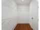 Walk-in closet with wire shelving and wood floor; a practical storage solution at 115 W Hiawatha St, Tampa, FL 33604