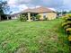 Expansive backyard, great for outdoor activities, with a view of the home's screened-in patio at 1185 Rio De Janeiro Ave, Punta Gorda, FL 33983