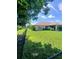 A black chain-link fence borders the backyard, providing privacy and security for outdoor enjoyment at 1185 Rio De Janeiro Ave, Punta Gorda, FL 33983