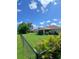 The spacious backyard is enclosed with a black chain-link fence and features a screen-enclosed patio at 1185 Rio De Janeiro Ave, Punta Gorda, FL 33983