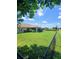 This home boasts a sprawling backyard featuring a screen-enclosed patio and mature landscaping along the fence at 1185 Rio De Janeiro Ave, Punta Gorda, FL 33983