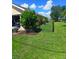 The backyard features a lush lawn, a black chain-link fence, and is conveniently gated at 1185 Rio De Janeiro Ave, Punta Gorda, FL 33983