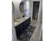 Modern bathroom with double sink vanity, granite counters, and decorative rug at 1185 Rio De Janeiro Ave, Punta Gorda, FL 33983