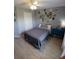 Guest bedroom with a queen bed, grey walls, and lots of charming decor at 1185 Rio De Janeiro Ave, Punta Gorda, FL 33983