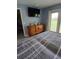 Comfortable bedroom featuring an dresser, television, and view to the outside at 1185 Rio De Janeiro Ave, Punta Gorda, FL 33983
