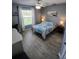 Comfortable bedroom with a ceiling fan, lamp lit nightstands, and a large bright window at 1185 Rio De Janeiro Ave, Punta Gorda, FL 33983