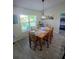 Bright dining room with wood table and chairs plus lovely views from the large window at 1185 Rio De Janeiro Ave, Punta Gorda, FL 33983