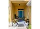Charming entryway with a bright teal door, complemented by potted plants and a welcoming ambiance at 1185 Rio De Janeiro Ave, Punta Gorda, FL 33983