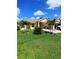 Well-manicured lawn with palm trees enhances the curb appeal of this attractive single-story home at 1185 Rio De Janeiro Ave, Punta Gorda, FL 33983