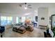Open concept living room flowing into the dining room and kitchen with modern flooring at 1185 Rio De Janeiro Ave, Punta Gorda, FL 33983