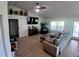 Spacious living room featuring a large sofa, ceiling fan, fireplace and lots of natural light at 1185 Rio De Janeiro Ave, Punta Gorda, FL 33983