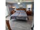 Light-filled main bedroom with a ceiling fan, ensuite, and a large comfortable bed at 1185 Rio De Janeiro Ave, Punta Gorda, FL 33983