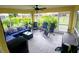 Screened porch with stylish outdoor seating and views of lush landscaping at 1185 Rio De Janeiro Ave, Punta Gorda, FL 33983