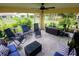 Screened porch with comfortable seating, potted plants and view to the backyard at 1185 Rio De Janeiro Ave, Punta Gorda, FL 33983