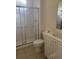 Bathroom features a glass-enclosed shower and vanity with a sink and storage at 12749 Aston Creek Dr, Tampa, FL 33626