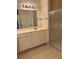 Bathroom featuring tile flooring, large mirror, walk-in shower and a double vanity at 12749 Aston Creek Dr, Tampa, FL 33626