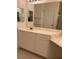 Bathroom with granite counters, large mirror, and vanity cabinet at 12749 Aston Creek Dr, Tampa, FL 33626