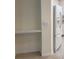 Hallway with built in shelf along with a white refrigerator at 12749 Aston Creek Dr, Tampa, FL 33626