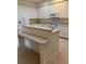 Spacious kitchen featuring white cabinets and a peninsula with a bar top at 12749 Aston Creek Dr, Tampa, FL 33626