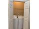 Convenient laundry room closet with a washer and dryer, including shelving at 12749 Aston Creek Dr, Tampa, FL 33626