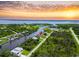 Stunning aerial view of waterfront home on canal with beautiful sunset backdrop at 13045 Irwin Dr, Port Charlotte, FL 33953
