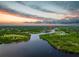 Incredible aerial view of waterway and neighborhood during twilight hours at 13045 Irwin Dr, Port Charlotte, FL 33953