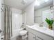 Bathroom featuring a neutral-toned shower curtain and vanity at 13045 Irwin Dr, Port Charlotte, FL 33953
