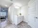 Bright bathroom featuring wood-look floors, a modern vanity, and a large mirror at 13045 Irwin Dr, Port Charlotte, FL 33953