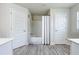 Simple bathroom featuring a shower and bathtub combination, bright lighting, and classic white fixtures at 13045 Irwin Dr, Port Charlotte, FL 33953