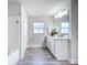 Clean bathroom with a double vanity, a large mirror, and a shower-tub combo at 13045 Irwin Dr, Port Charlotte, FL 33953