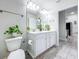Bright bathroom features a double sink vanity, white cabinets, and a modern design with stylish fixtures at 13045 Irwin Dr, Port Charlotte, FL 33953