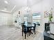 Bright dining area with round glass table and seating for four, overlooking the outdoor pool and waterway at 13045 Irwin Dr, Port Charlotte, FL 33953