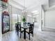 Elegant dining room featuring a glass table, chandelier, and large windows at 13045 Irwin Dr, Port Charlotte, FL 33953