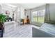 Inviting foyer with hardwood floors, large window, and views into the dining room at 13045 Irwin Dr, Port Charlotte, FL 33953