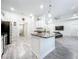 Modern kitchen with granite countertops, stainless steel appliances, and an island at 13045 Irwin Dr, Port Charlotte, FL 33953