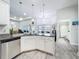 Well-lit kitchen featuring white cabinets, granite countertops, stainless steel appliances, and an island with bar seating at 13045 Irwin Dr, Port Charlotte, FL 33953