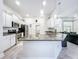 Open concept kitchen with granite countertops, stainless steel appliances, and a central island with a sink at 13045 Irwin Dr, Port Charlotte, FL 33953