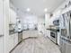 Spacious kitchen with stainless steel appliances, granite countertops, and ample white cabinetry at 13045 Irwin Dr, Port Charlotte, FL 33953