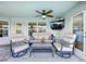 Relaxing covered patio featuring comfortable seating and a TV for outdoor enjoyment at 13045 Irwin Dr, Port Charlotte, FL 33953