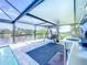 Covered pool patio features outdoor kitchen and waterfront views perfect for entertaining at 13045 Irwin Dr, Port Charlotte, FL 33953