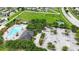 Aerial view of park featuring a pool, dog park, and green spaces within the community at 14524 Dunrobin Dr, Wimauma, FL 33598