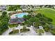 Aerial view of pool, clubhouse, and green spaces within the community at 14524 Dunrobin Dr, Wimauma, FL 33598