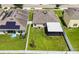 Overhead view of home, highlighting the spacious backyard with a screened patio and privacy fence at 14524 Dunrobin Dr, Wimauma, FL 33598