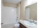 Bathroom featuring a shower-tub combo, granite vanity, and a large mirror at 14524 Dunrobin Dr, Wimauma, FL 33598